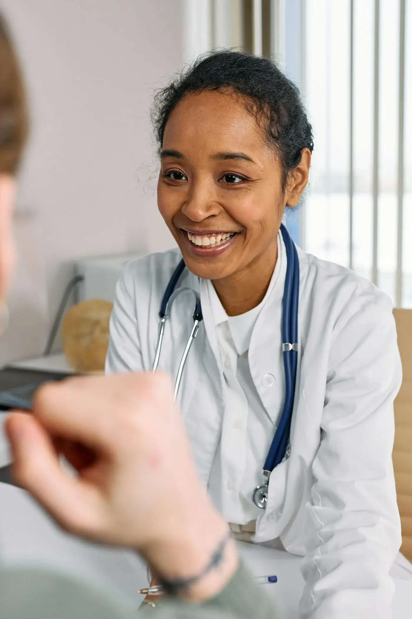Front desk staff coordinating appointments with patient support